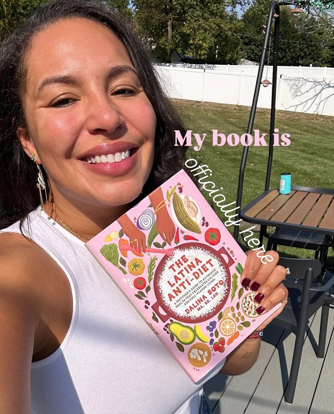 Dalina Soto holding her book, The Latina Anti-Diet